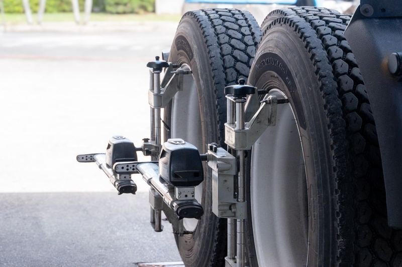 Computerized alignment sensors mounted on a truck wheel