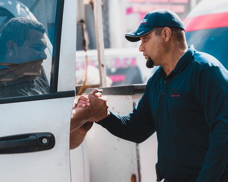 Alex Truck Tire technician shaking hands with a truck driver